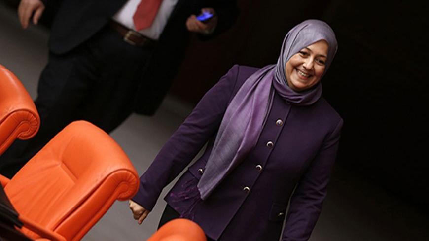 Turkey's ruling AK Party (AKP) lawmaker Sevde Beyazit Kacar arrives to the general assembly wearing her headscarf at the Turkish Parliament in Ankara October 31, 2013. Four female lawmakers from Turkey's Islamist-rooted ruling party wore their Islamic head scarves in parliament on Thursday in a challenge to the country's secular tradition. Four female lawmakers, Nurcan Dalbudak, Sevde Beyazit Kacar, Gulay Samanci and Gonul Bekin Sahkulubey, from Turkey's Islamist-rooted ruling party AKP wore their Islamic h