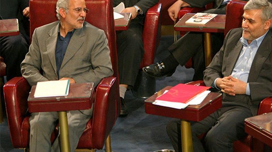 SAFDAR HOSSEINI, IRAN'S NEW MINISTER OF ECONOMY AND FINANCE AND NASSER KHALEQI MINISTER OF LABOUR AND SOCIAL AFFAIRS SPEAK AT PARLIAMENTARY CONFIRMATION IN TEHRAN.  Safdar Hosseini(R), Iran's new Minister of the economy and finance and Nasser Khaleqi Minister of Labour and Social Affairs speak with one another during their parliamentary confirmation in Tehran April 25, 2004. Iran's reformist-dominated parliament approved President Mohammad Khatami's nominees for new economy and labour ministers, a move crit