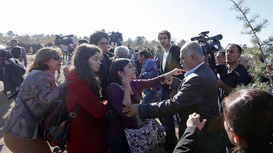 Protesters argue with municipality workers during a demonstration against reconstruction plans that include a part of the Middle East Technical University campus in Ankara October 21, 2013. The municipality plan, opposed by the students, involves building a road across the Middle East Technical University campus and uprooting a large number of trees in the area. REUTERS/Umit Bektas (TURKEY - Tags: POLITICS CIVIL UNREST EDUCATION) - RTX14IMG