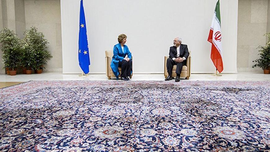 European Union foreign policy chief Catherine Ashton (L) speaks with Iranian Foreign Minister Mohammad Javad Zarif during a photo opportunity before the start of two days of closed-door nuclear talks at the United Nations offices in Geneva October 15, 2013. Iran will face pressure on Tuesday to propose scaling back its nuclear programme to win relief from crippling sanctions as talks between world powers and Tehran resume after a six-month hiatus. REUTERS/Fabrice Coffrini/Pool (SWITZERLAND - Tags: ENERGY PO