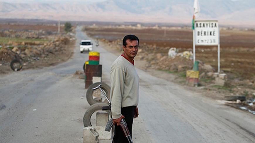 A Syrian Kurd Asaish stands at a security checkpoint at Derik in Al-Hasakah October 31, 2012. Picture taken October 31, 2012. REUTERS/Thaier al-Sudani (SYRIA - Tags: CIVIL UNREST CONFLICT) - RTR39WOM