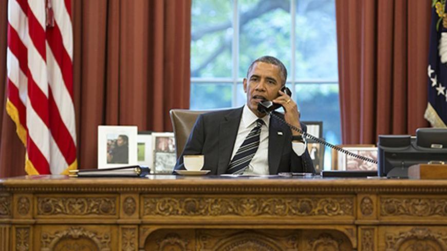 U.S. President Barack Obama talks with Iranian President Hassan Rouhani during a phone call in the Oval Office at the White House in Washington September 27, 2013. U.S. President Barack Obama and new Iranian President Hassan Rouhani held the historic phone call on Friday, in the highest level conversation between the estranged nations in more than three decades. Speaking to reporters at the White House, Obama said both men had directed their teams to work expeditiously toward an agreement on Iran's nuclear 