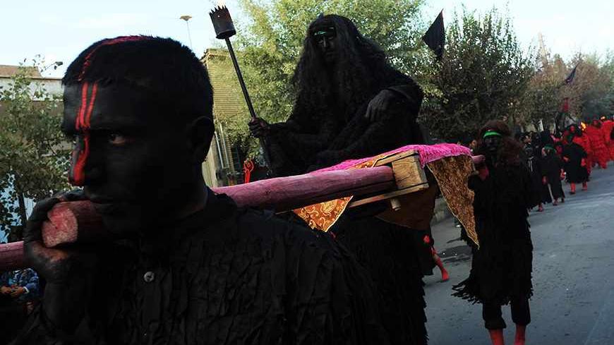 NOOSH ABAD, IRAN - NOVEMBER 13: Iranian Shiite Muslims enact the story of killing Imam Hussein during the annual religious performance of "Taazieh" November 13, 2013 in Noosh Abad near the central city of Kashan, Iran. The event marks the mourning period of Ashura commemorations, in which Imam Hussein, grandson of Islam's Prophet Mohammed, was killed by armies of the caliph Yazid near Karbala in 680 AD.  (Photo by Majid Saeedi/Getty Images)