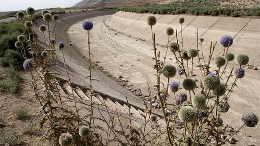 A general view shows a dried-up water canal in Eghlid in the southern Iranian province of Fars on July 8, 2008. According to local legend, Cyrus the Great, founder of the Persian Empire, abhorred the telling of lies, which he believed to be his people's worst enemy. It is said that next in line was drought. Little has changed for the modern-day descendants of those who lived 2,500 years ago in what is now Iran. Eghlid has 11 rivers -- but 10 of them have now run dry. The agricultural town's altitude of 2,23