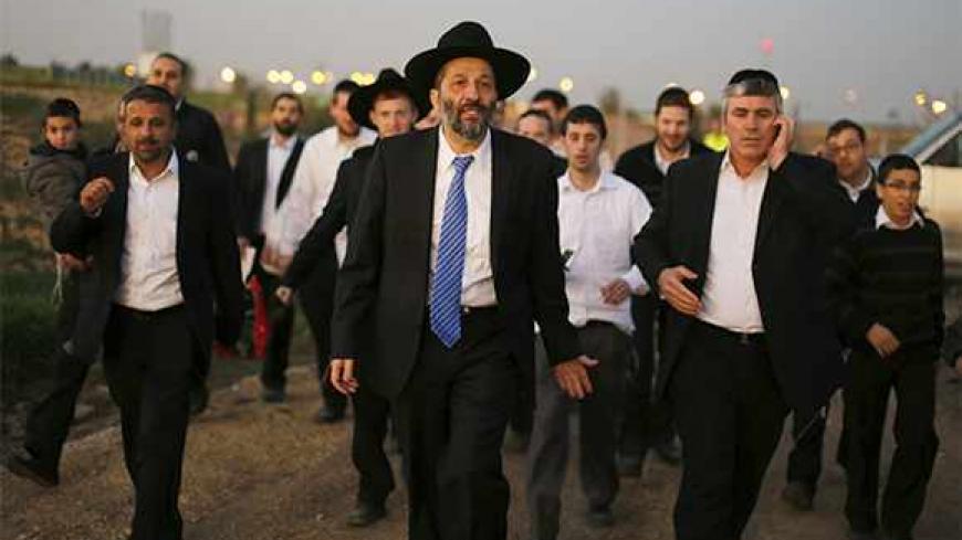 Aryeh Deri (C), leader of the ultra-Orthodox Shas party, attends an annual pilgrimage to the gravesite of Rabbi Yisrael Abuhatzeira, a Moroccan-born sage and kabbalist also known as the Baba Sali, in the southern town of Netivot January 14, 2013.  Powerful political players for years, Israel's ultra-Orthodox parties must now reckon with a new force ushered in by voters bent on stripping them of perks they have relied on for decades. Picture taken January 14, 2013. REUTERS/Amir Cohen (ISRAEL - Tags: POLITICS