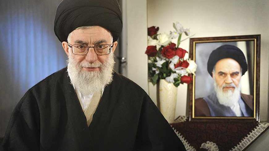 EDITORS' NOTE: Reuters and other foreign media are subject to Iranian restrictions on their ability to film or take pictures in Tehran.
Iran's Supreme Leader Ayatollah Ali Khamenei sits next to a portrait of late leader Ayatollah Ruhollah Khomeini while taking part in a television live programme in Tehran on the occasion of the Iranian New Year March 21, 2011. REUTERS/Leader.ir/Handout (IRAN - Tags: POLITICS PROFILE) THIS IMAGE HAS BEEN SUPPLIED BY A THIRD PARTY. IT IS DISTRIBUTED, EXACTLY AS RECEIVED BY