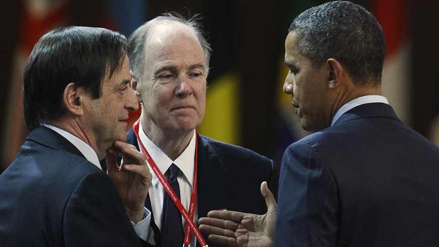U.S. President Barack Obama (R) speaks to Israel's Deputy Prime Minister Dan Meridor at a plenary session during the Nuclear Security Summit at the Convention and Exhibition Center (COEX) in Seoul March 27, 2012. The man at centre at an unidentified member of the U.S. delegation. REUTERS/Larry Downing (SOUTH KOREA  - Tags: POLITICS MILITARY)   - RTR2ZXN6