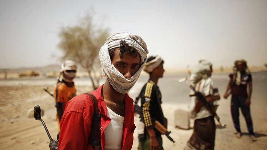 Pro-army tribesmen man a checkpoint on a road leading to Lawdar town in the southern Yemeni province of Abyan June 19, 2012. Al Qaeda-linked militants retreated from Lawdar last month after encountering stiff resistance from pro-army tribal fighters, who have arranged themselves into popular committees to defend their town against attempts by the militants to control it. Yemen's army recaptured the last al Qaeda stronghold in restive Abyan province on Friday in a major advance in its U.S.-backed offensive t