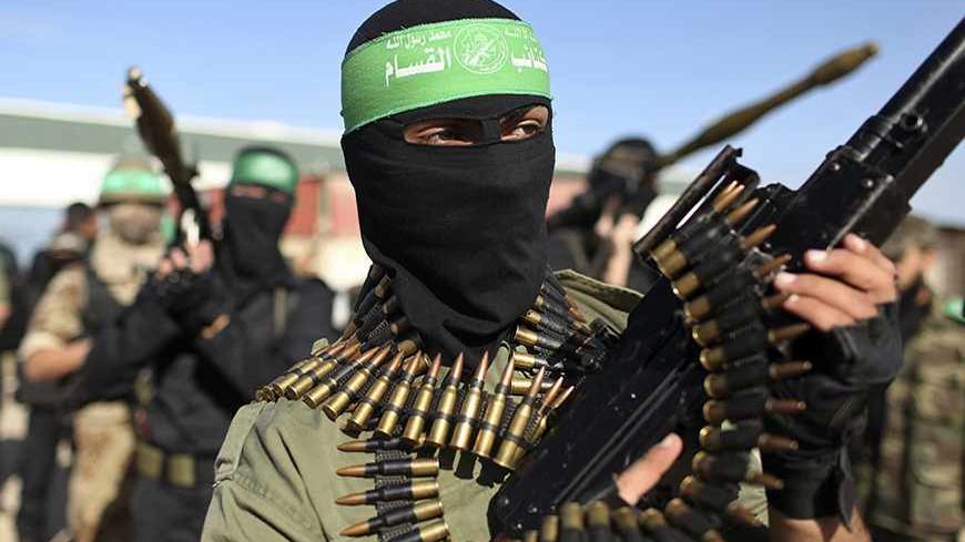 Palestinian members of the al-Qassam brigades, the armed wing of the Hamas movement, stand guard as they wait for the arrival of Hamas chief Khaled Meshaal in Rafah in the southern Gaza Strip December 7, 2012. Hamas's exiled leader Meshaal will step onto Palestinian land for the first time in 45 years on Friday for a "victory rally" in the Gaza Strip, displaying his newfound confidence after last month's conflict with Israel. Meshaal, the Islamist group's leader, who has not visited the Palestinian Territor