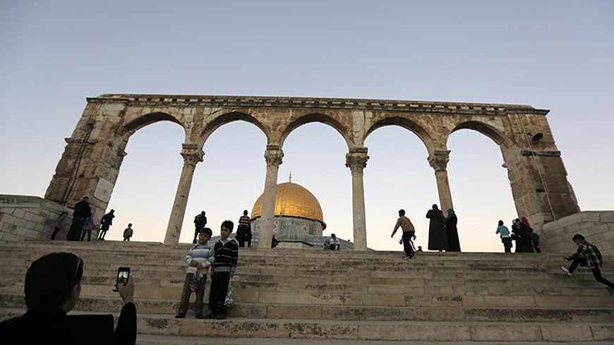 Palestinian children have their picture taken in front of the Dome of the Rock on the compound known to Muslims as al-Haram al-Sharif and to Jews as Temple Mount in Jerusalem's Old city, on the first day of Eid al-Adha October 15, 2013. Muslims around the world celebrate Eid al-Adha to mark the end of the Haj by slaughtering sheep, goats, cows and camels to commemorate Prophet Abraham's willingness to sacrifice his son Ismail on God's command. REUTERS/Ammar Awad (JERUSALEM - Tags: RELIGION) - RTX14BUK