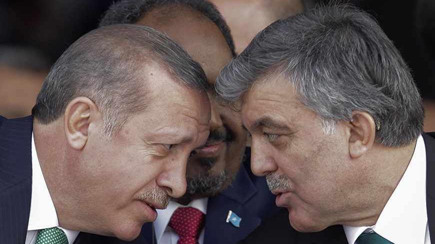 Turkey's President Abdullah Gul (R) and Prime Minister Tayyip Erdogan (L) chat as President of Somalia Hassan Sheikh Mohamud sits between them during the opening ceremony of Marmaray, a subway links Europe with Asia some 60 metres below the Bosphorus Strait, in Istanbul October 29, 2013. Turkey opened the world's first underwater rail link between two continents on Tuesday, connecting Asia and Europe and allowing Prime Minister Tayyip Erdogan to realise a project dreamt up by Ottoman sultans more than a cen