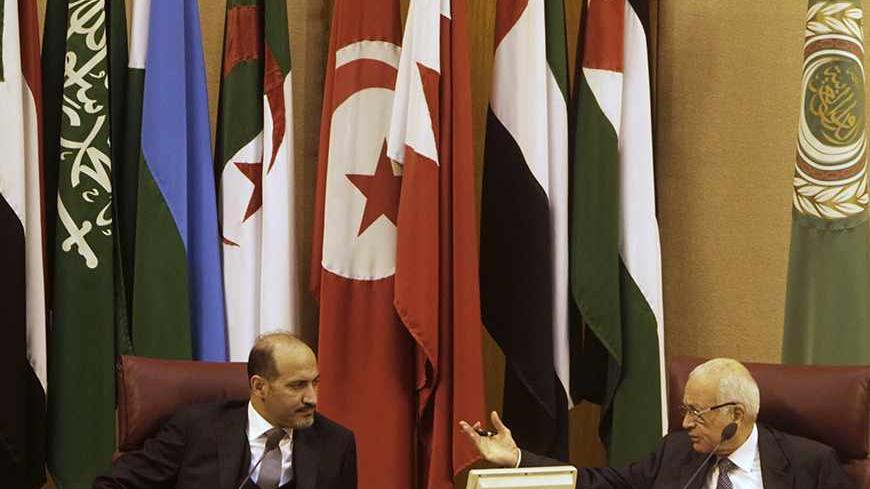 Arab League Secretary General Nabil al-Arabi (R) speaks to President of the Syrian National Coalition Ahmad Jarba during the Arab foreign ministers' meeting in Cairo November 3, 2013. The Syrian opposition set terms on Sunday for attending peace talks to end the Syrian civil war, in a move that throws the proposed conference into further confusion after the international envoy said there should be no preconditions. REUTERS/Mohamed Abd El Ghany (EGYPT - Tags: POLITICS) - RTX14Z0R
