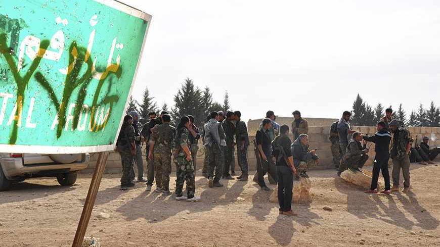 Members of the Kurdish People's Protection Units (YPG) carry their weapons as they gather in Tal Arqum, near the city of Ras al- Ain, after capturing it from Islamist rebels November 5, 2013. Redur Xelil, spokesman for the armed wing of the Syrian Kurdish Democratic Union Party (PYD), said Kurdish militias had seized the city of Ras al-Ain and all its surrounding villages. Syrian Kurdish fighters have captured more territory from Islamist rebels in northeastern Syria, a Kurdish militant group said on Monday
