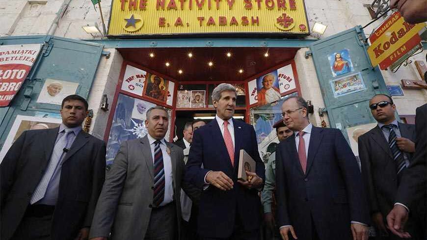 U.S. Secretary of State John Kerry walks out after shopping for souvenirs at "The nativity Store" in Manger Square, Bethlehem, November 6, 2013. Kerry was in Bethlehem to promote USAID's assistance in improving infrastructure projects in the West Bank. REUTERS/Jason Reed (WEST BANK - Tags: POLITICS) - RTX15284