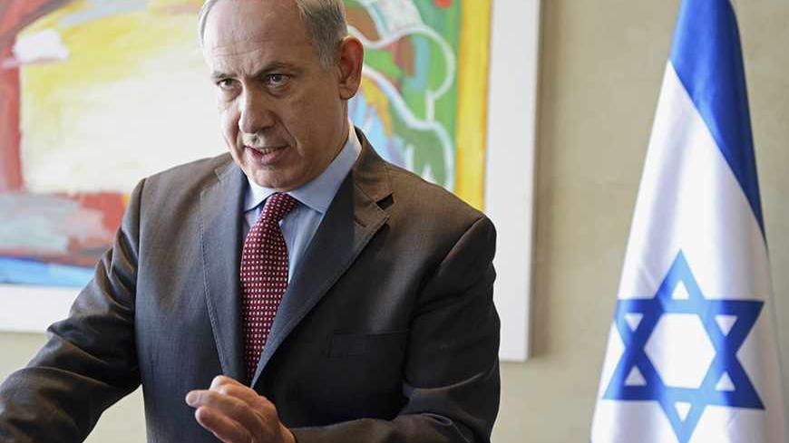 Israeli Prime Minister Benjamin Netanyahu gestures as he delivers a statement to the media after meeting U.S. Secretary of State John Kerry at Ben Gurion Airport near Tel Aviv November 8, 2013. Israel rejected out of hand on Friday a mooted deal between world powers and Iran, just as Kerry prepared to join nuclear talks that aim to nail down an interim agreement on the decade-old standoff. REUTERS/Debbie Hill/Pool (ISRAEL - Tags: POLITICS) - RTX1555A