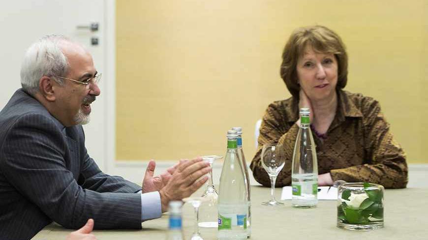 Iranian Foreign Minister Mohammad Javad Zarif (L) and European Union foreign policy chief Catherine Ashton speak during the third day of closed-door nuclear talks at the Intercontinental Hotel in Geneva November 9, 2013. REUTERS/Jean-Christophe Bott/Pool  (SWITZERLAND - Tags: POLITICS ENERGY) - RTX156EI