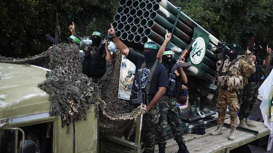 Palestinian Hamas militants take part in a military parade marking the first anniversary of the eight-day conflict with Israel, in Gaza City November 14, 2013. Eight days of Israeli air strikes on Gaza and cross-border Palestinian rocket attacks in November last year ended in an Egyptian-brokered truce agreement calling on Israel to ease restrictions on the territory. REUTERS/Suhaib Salem (GAZA - Tags: POLITICS ANNIVERSARY CONFLICT MILITARY) - RTX15DDP