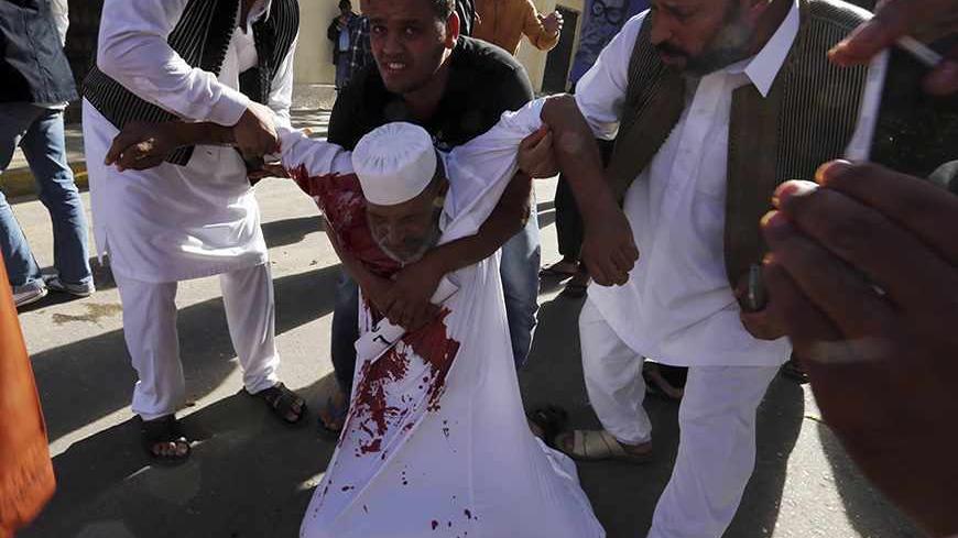 ATTENTION EDITORS - VISUAL COVERAGE OF SCENES OF INJURY OR DEATH

People carry a man who was injured when Libyan militiamen opened fire into a crowd of protesters in Tripoli November 15, 2013. Six people were killed and dozens more wounded in clashes between militiamen and armed residents in the capital Tripoli on Friday, state television said, in a further challenge to Libya's weak government. The bloodshed began when militiamen opened fire into hundreds of protesters demanding their eviction from the capi