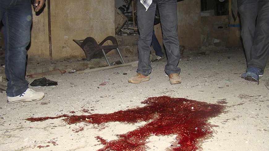 Blood stains are seen on the ground after a suicide bombing at the Kurdish Internal Security Forces Center (Asayish) at the Suez Canal neighbourhood in Qamishli November 23, 2013. The al-Qaeda linked Islamic State of Iraq and the Levant have claimed responsibility for the bombing which killed three people, including two members of the Asayish police force, and nine others wounded, activists said. Picture taken November 23, 2013. REUTERS/Massoud Mohammed (SYRIA - Tags: POLITICS CIVIL UNREST CONFLICT) - RTX15