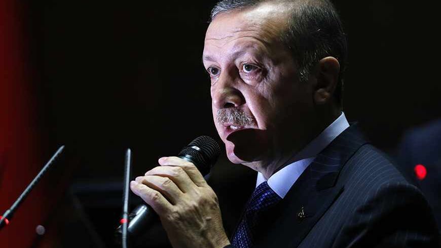 Turkey's Prime Minister Tayyip Erdogan addresses members of parliament from his ruling AK Party (AKP) during a meeting at the Turkish parliament in Ankara November 26, 2013. REUTERS/Umit Bektas (TURKEY - Tags: POLITICS) - RTX15TO8