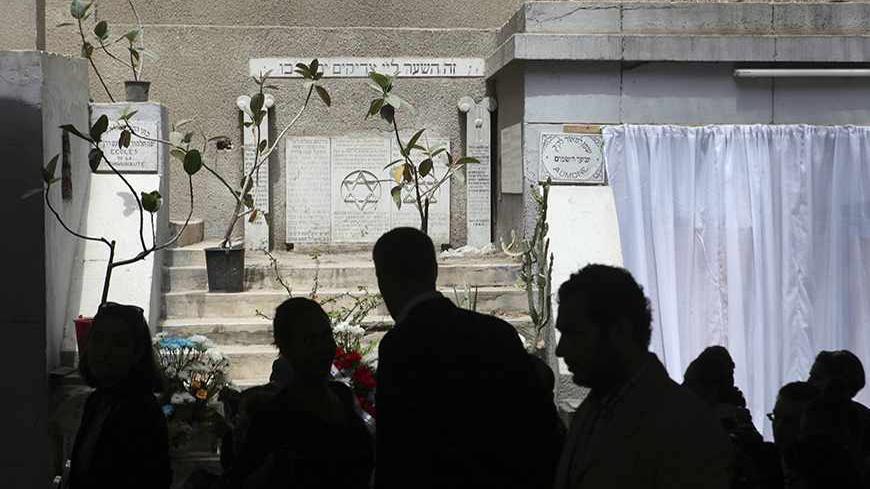 Diplomats from the United States and Israel are silhouetted as they join about 100 mourners at a ceremony, held on Thursday in memory of veteran Jewish leader Carmen Weinstein, at Sha'ar Hashamayim (Gate of Heaven) synagogue in downtown Cairo, April 18, 2013. Weinstein, 82, died last Saturday at her home in Cairo where she was known over the past two decades for leading efforts to preserve the overwhelmingly Muslim country's Jewish heritage. REUTERS/Asmaa Waguih (EGYPT - Tags: RELIGION POLITICS OBITUARY) -