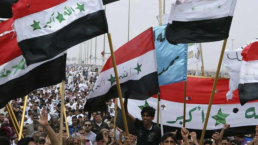 Iraqi Sunni Muslims wave the old flags of Iraq during an anti-government demonstration in Falluja, 50 km (31 miles) west of Baghdad May 3, 2013. Tens of thousands of Sunni Muslims poured onto the streets of Ramadi and Falluja in the western province of Anbar following Friday prayers, in their biggest show of strength since the outbreak of protests last year. REUTERS/Mohanned Faisal (IRAQ - Tags: POLITICS RELIGION CIVIL UNREST) - RTXZ987