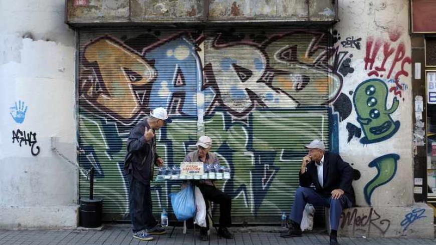 National lottery sellers (L and C) chat on the main shopping and pedestrian street of Istiklal in central Istanbul September 27, 2013. REUTERS/Murad Sezer (TURKEY - Tags: SOCIETY) - RTX1428N
