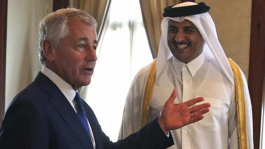 U.S. Secretary of Defense Chuck Hagel (L) meets with Qatar's Emir Sheikh Tamim bin Hamad in Doha December 10, 2013. Hagel briefed Qatari leaders on Tuesday about the effort to destroy Syria's chemical weapons, and he underscored U.S. support for Syria's moderate opposition. Picture taken December 10, 2013, REUTERS/Mark Wilson/Pool (QATAR - Tags: POLITICS) - RTX16DFR