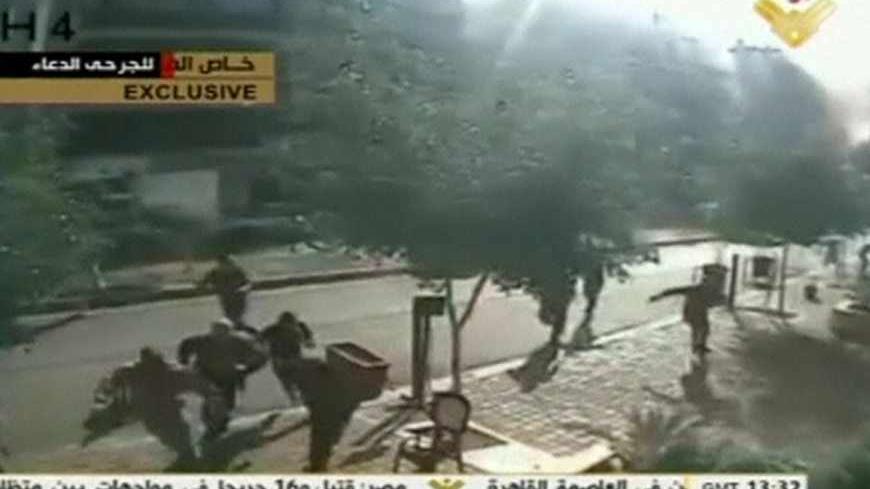 People run after the second blast rocked the Iranian embassy compound in Beirut in this still image taken from a security camera near the embassy, November 19, 2013. Two suicide bombings rocked Iran's embassy compound in Lebanon on November 19, killing at least 23 people including an Iranian cultural attache and hurling bodies and burning wreckage across a debris-strewn street, with at least 146 wounded. Image taken November 19, 2013.     REUTERS/Al Manar via Reuters TV    (LEBANON - Tags: POLITICS CIVIL UN