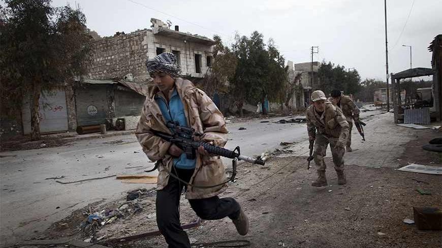 TO GO WITH AFP STORY BY ANTONIO PAMPLIEGA
Syrian Turkmen rebels run across a street controlled by regime forces to dodge sniper fire in the Hanano district of the northern city of Aleppo on January 28, 2013. Members of Syria's Turkmen minority have joined forces with rebels fighting President Bashar al-Assad's regime in a struggle they say is for democracy and revenge for years of oppression. AFP PHOTO/JM LOPEZ (Photo credit should read JM LOPEZ/AFP/Getty Images)