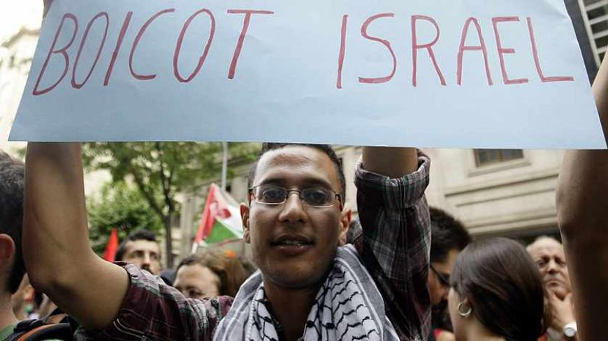 Demonstrators shout slogans as a man shows a banner which reads "boycott Israel" during an anti-Israel protest in front of Chamber of Commerce Israel-Catalunya in Barcelona May 31, 2010. Israeli marines stormed a Turkish aid ship bound for Gaza on Monday and 10 pro-Palestinian activists were killed, triggering a diplomatic crisis and plans for an emergency session of the U.N. Security Council. REUTERS/Albert Gea (SPAIN - Tags: POLITICS CIVIL UNREST) - RTR2ELSN