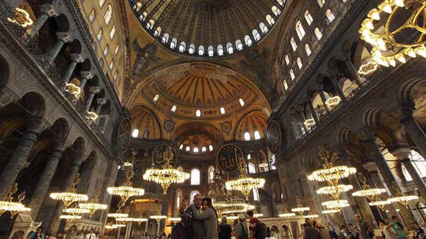 A Macedonian couple (C) takes souvenir pictures as they visit the Byzantine monument of Hagia Sophia or Ayasofya, now a museum, in Istanbul May 25, 2011. The number of foreign visitors to Turkey rose 31.3 percent year-on-year in April to 2.29 million people, the Tourism Ministry said on Wednesday, after climbing 14.36 percent in March. Last year, the number of visitor arrivals rose 5.74 percent to 28.6 million. REUTERS/Murad Sezer (TURKEY - Tags: TRAVEL SOCIETY) - RTR2MVLK