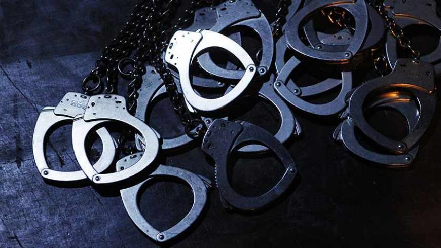 The handcuffs of inmates are seen during a play at a public theatre in Lima, June 20, 2012. About 20 young inmates of Ancon prison put on stage their own theatrical script, based on their testimonies in jail, outside prison after four months of rehearsal. The event, organized by prison authorities, aims to help them reintegrate into society when they get released in future. REUTERS/Enrique Castro-Mendivil (PERU - Tags: SOCIETY CRIME LAW) - RTR33Y1I