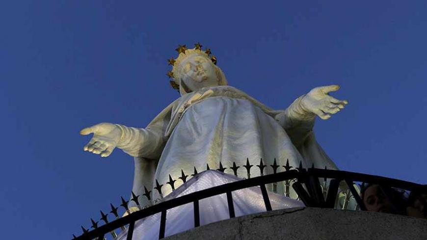 Faithful Christians pray at the monument of our Lady of Lebanon in Harissa village, north of Beirut, August 18, 2012, marking the Assumption of the Virgin Mary. Pope Benedict XVI will be visiting Lebanon from September 14 to 16. REUTERS/Jamal Saidi   (LEBANON - Tags: RELIGION) - RTR36YAB