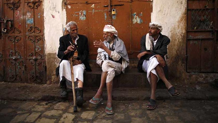 People chat as they sit at a marketplace in the Old Sanaa city November 18, 2012. REUTERS/Khaled Abdullah (YEMEN - Tags: SOCIETY) - RTR3AK1H