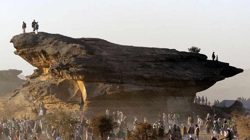 Dust rises as followers of Yemen's al-Houthi Shi'ite group leave a ceremony held during Eid-e-Milad-ul-Nabi, the birthday celebrations of Prophet Mohammad, in Dhahian of the northwestern Yemeni province of Saada January 24, 2013. REUTERS/Mohamed al-Sayaghi (YEMEN - Tags: CIVIL UNREST POLITICS ANNIVERSARY) - RTR3CWPJ