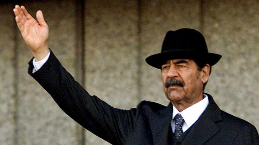 The U.S. military has apparently captured former Iraqi President Saddam Hussein in a raid in his home town of Tikrit, a defense official said on December 14, 2003. This December 31, 2001 file photo shows Iraqi President Saddam Hussein waving to a crowd in Baghdad. REUTERS/Faleh Kheiber SJS/CMC - RTR8RO2