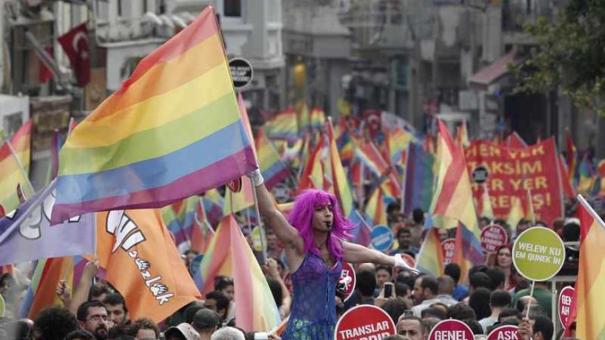 A participant holds a rainbow flag during a gay pride parade in central Istanbul June 30, 2013. Tens of thousands of anti-government protesters teamed up with a planned gay pride march in Istanbul. Crowds were stopped by riot police from entering Taksim, the centre of previous protests, but the atmosphere appeared peaceful. REUTERS/Osman Orsal (TURKEY - Tags: CIVIL UNREST POLITICS SOCIETY) - RTX1176G