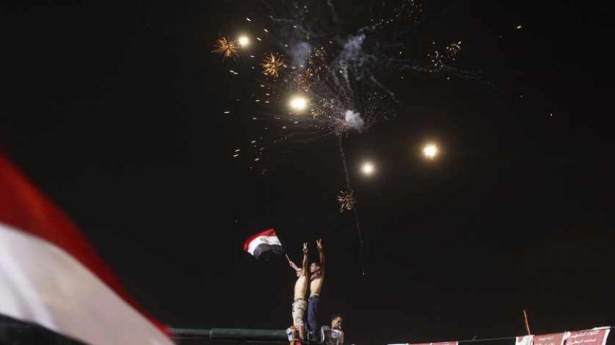 Anti-Mursi protesters celebrate in Tahrir square after the announcement of the removal from office of Egypt's deposed President Mohamed Mursi in Cairo, July 3, 2013. Mursi, toppled by the military on Wednesday, is being held by the authorities, a Muslim Brotherhood spokesman and a security official said on Thursday. REUTERS/Asmaa Waguih (EGYPT - Tags: POLITICS CIVIL UNREST TPX IMAGES OF THE DAY) - RTX11BTC