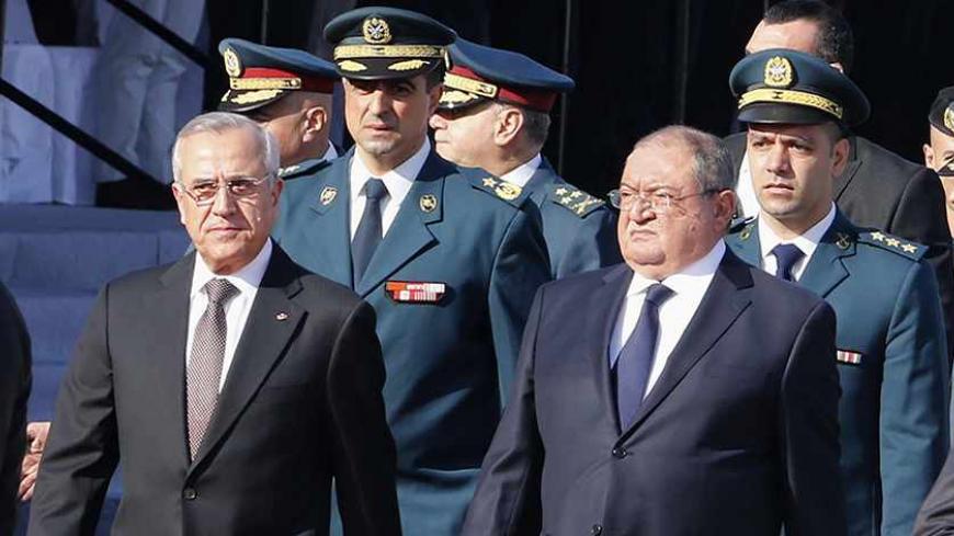 Lebanon's President Michel Suleiman (L) and Defence Minister Fayez Ghosn arrive to attend a military parade to celebrate the 70th anniversary of Lebanon's independence in downtown Beirut November 22, 2013. REUTERS/Mohamed Azakir (LEBANON - Tags: ANNIVERSARY POLITICS MILITARY) - RTX15OFG