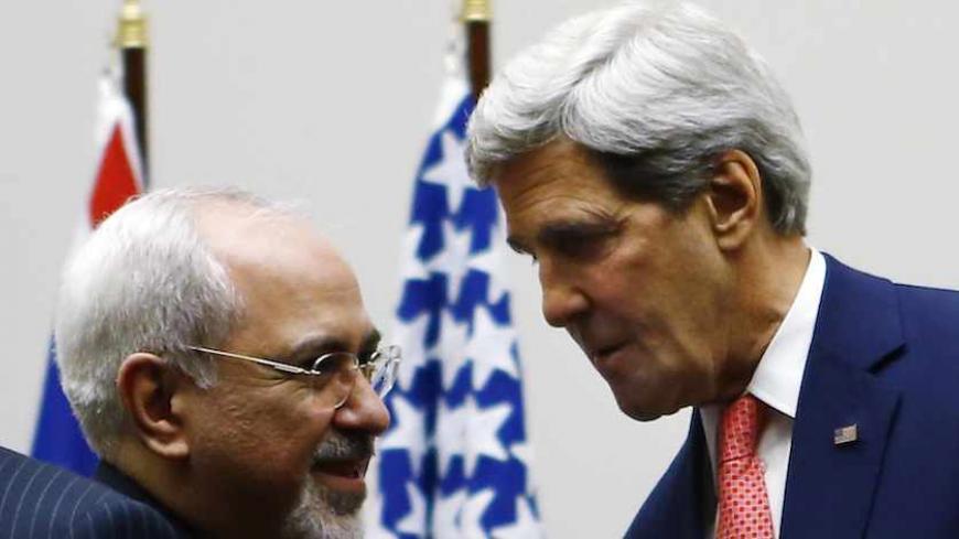 U.S. Secretary of State John Kerry (R) shakes hands with Iranian Foreign Minister Mohammad Javad Zarif after a ceremony at the United Nations in Geneva November 24, 2013. Iran and six world powers reached a breakthrough agreement early on Sunday to curb Tehran's nuclear programme in exchange for limited sanctions relief, in a first step towards resolving a dangerous decade-old standoff. REUTERS/Denis Balibouse (SWITZERLAND - Tags: POLITICS ENERGY) - RTX15QLU