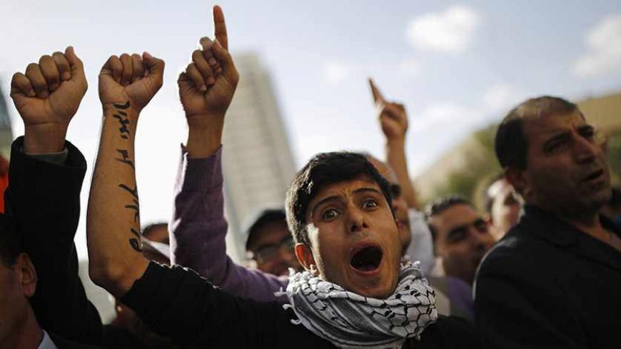 Members of the Bedouin community gesture during a protest outside a court in the southern city of Beersheba, calling to release people who were arrested last Saturday in protests against a government plan to force 40,000 Bedouins living in the southern Negev region to leave their villages, December 5, 2013. Hundreds of Bedouin Arabs and their supporters clashed with Israeli forces on Saturday in the protests, in which, according to an Israeli police spokesman, at least 28 people had been arrested. REUTERS/A