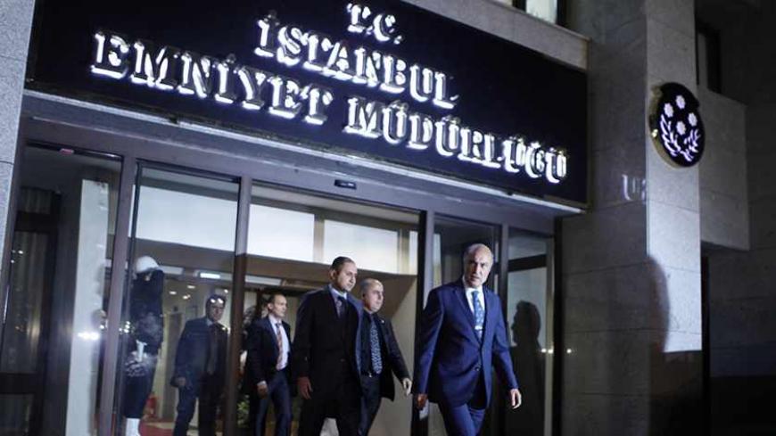 Istanbul police chief Huseyin Capkin (Front) leaves the police headquarters in Istanbul December 18, 2013. Turkish Deputy Prime Minister Bulent Arinc said on Wednesday a corruption investigation in which 52 people including the sons of three cabinet ministers have been detained was part of a "planned operation" to tarnish the government. In the first official comments on the investigation from a senior member of the government, Arinc also said politics would not be allowed to stand in the way of the inquiry