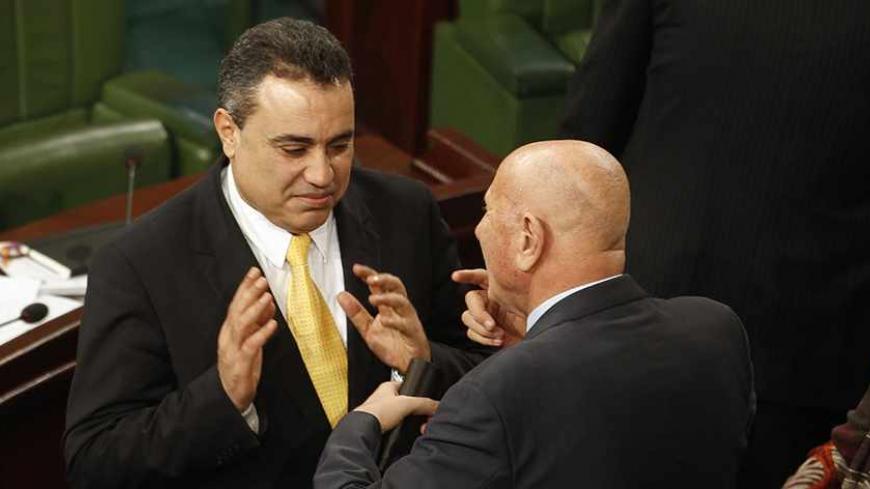 Tunisia's prime minister-designate Mehdi Jomaa (L) speaks with Nejib Chebbi, leader of the Al Joumhouri party, in the constituent assembly in Tunis December 25, 2013. REUTERS/Zoubeir Souissi (TUNISIA - Tags: POLITICS) - RTX16TSI