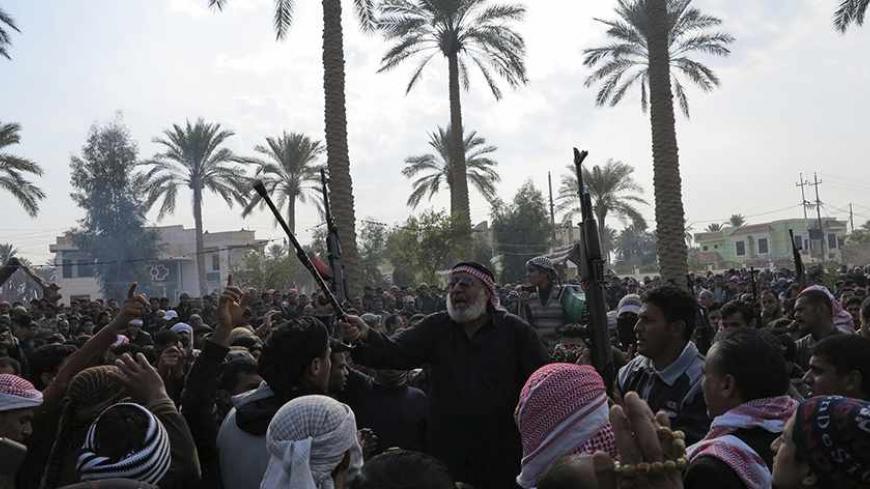 Residents gather to protest near the house of prominent Sunni Muslim lawmaker Ahmed al-Alwani, in the centre of Ramadi, December 29, 2013. Iraqi security forces arrested Alwani in a raid on his home in the western province of Anbar, sparking clashes in which at least five people were killed, police sources said. Picture taken December 29, 2013. REUTERS/Ali al-Mashhadani (IRAQ - Tags: POLITICS CIVIL UNREST) - RTX16X7L