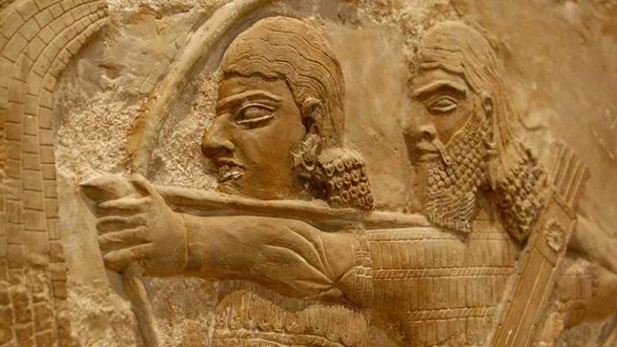 Assyrian mural sculptures are displayed in the Iraqi national museum in Baghdad September 24, 2008.  In Iraq's national museum, a frieze shows an Assyrian king, whose former capital is now in modern Iraq, besieging what looks like a walled town as soldiers pile decapitated heads at his feet. Picture taken September 24, 2008. To match feature IRAQ/MUSEUM     REUTERS/Ceerwan Aziz (IRAQ) - RTX95P0
