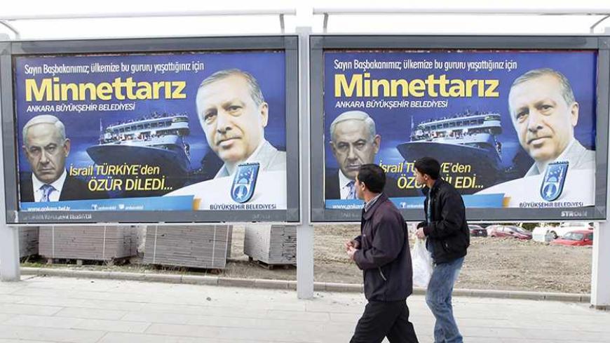 Pedestrians look at billboards with the pictures of Turkey's Prime Minister Tayyip Erdogan (R) and his Israeli counterpart Benjamin Netanyahu (L), in Ankara March 25, 2013. Turkey's Prime Minister Tayyip Erdogan said on Saturday an Israeli apology for the 2010 deaths of nine Turkish pro-Palestinian activists that was brokered by U.S. President Barack Obama met Turkey's conditions and signalled its growing regional clout. The billboard reads, "Israel apologized to Turkey. Dear Prime Minister (Erdogan), We ar