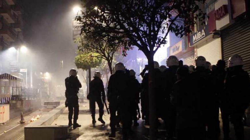 Riot police fire teargas during a protest against Turkey's ruling Ak Party (AKP) and Prime Minister Tayyip Erdogan in Istanbul December 25, 2013. Turkey's Prime Minister Tayyip Erdogan presented a new list of cabinet ministers to President Abdullah Gul on Wednesday after three ministers resigned over a high-level graft inquiry, sources said. It was unclear if more than the resigned ministers had been replaced. Erdogan is expected to make a statement later amid the spiralling corruption scandal. REUTERS/Osma