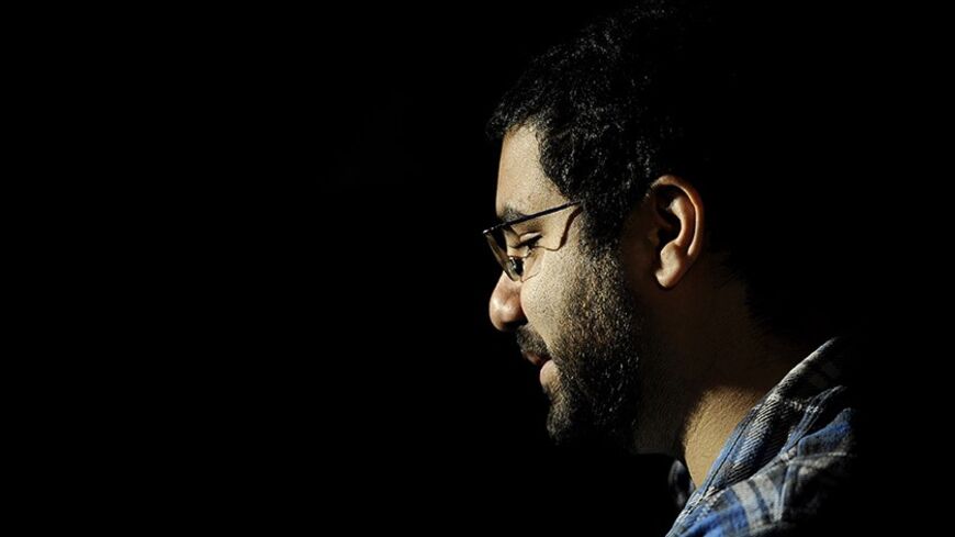 Egyptian blogger and activist Alaa Abdel Fattah gives a TV interview at his house in Cairo on December 26, 2011, a day after his release. Abdel Fattah, who was remanded into custody on October 30 and who was also jailed under ousted president Hosni Mubarak, was accused of inciting violence during an October 9 demonstration by Coptic Christians. AFP PHOTO / Filippo MONTEFORTE (Photo credit should read FILIPPO MONTEFORTE/AFP/Getty Images)