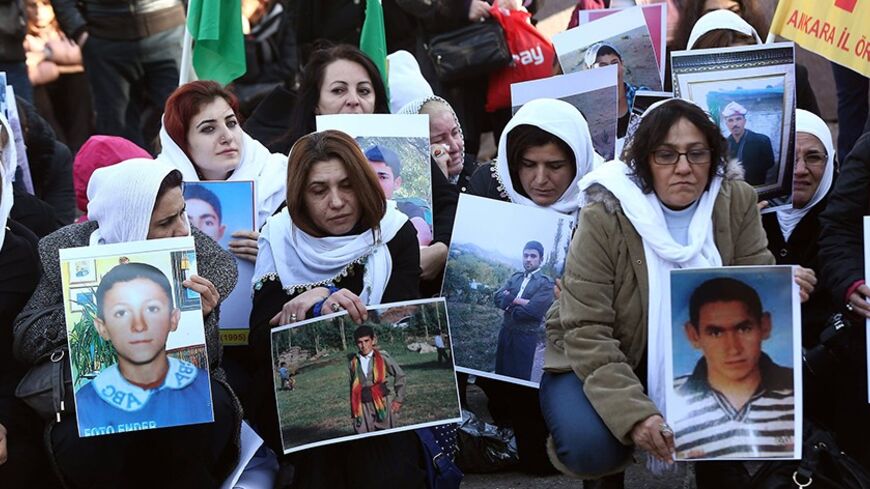 Relatives of the 34 Turkish Kurdish civilians who were killed in Decemeber 2011 in a botched raid in Uludere at Turkey-Iraq border by Turkish military jets that mistook the group for Kurdish rebels based in Iraq, hold pictures as they stage a protest in Ankara on December 28, 2013.      AFP PHOTO / ADEM ALTAN        (Photo credit should read ADEM ALTAN/AFP/Getty Images)